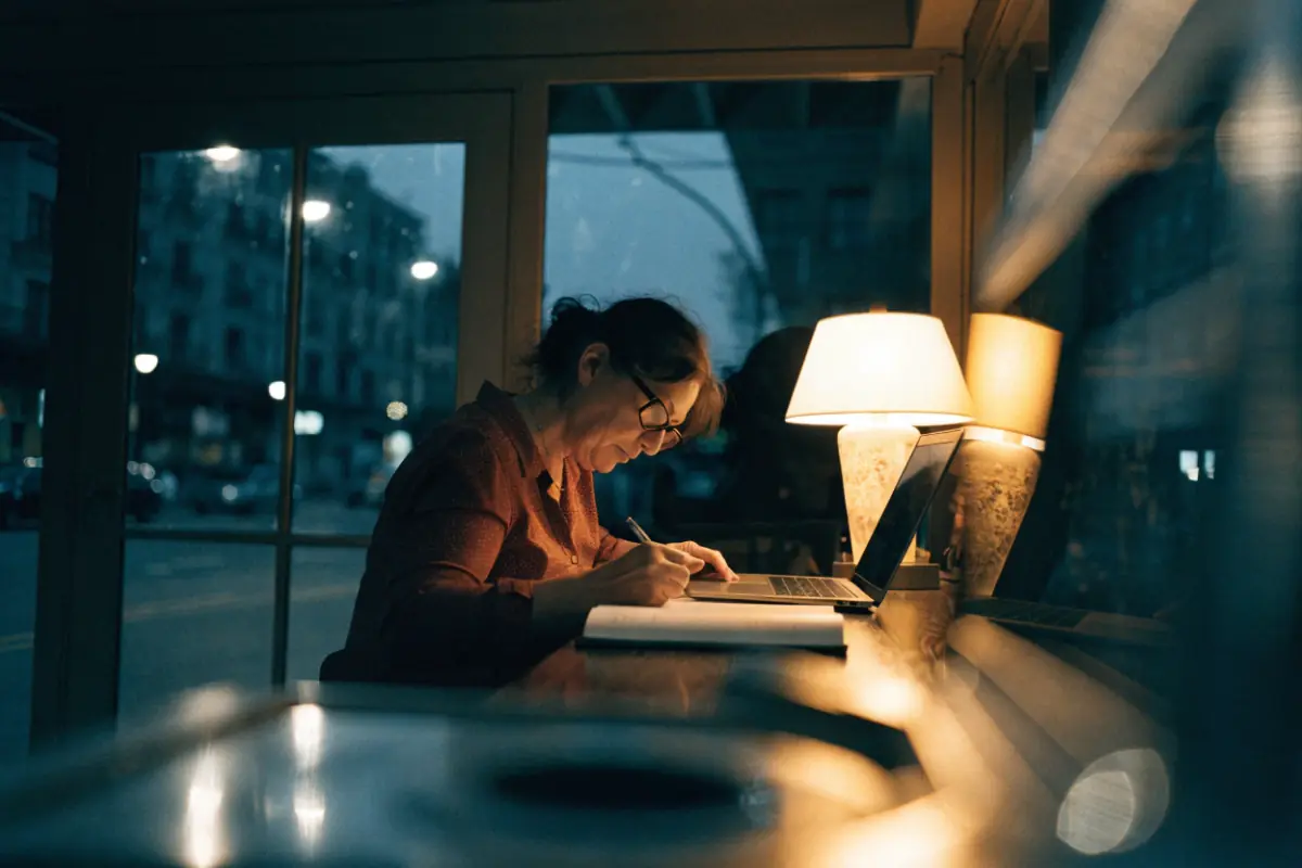 A shop owner looking over the year's books at closing time