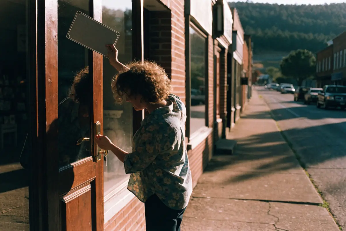 A local shop owner opening her storefront in the morning