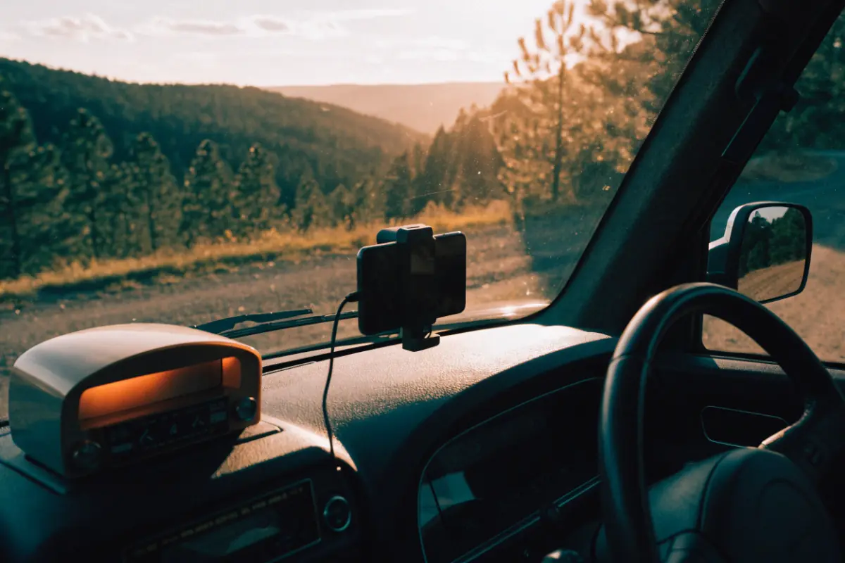 A truck radio on one side and a phone on the dashboard on the other